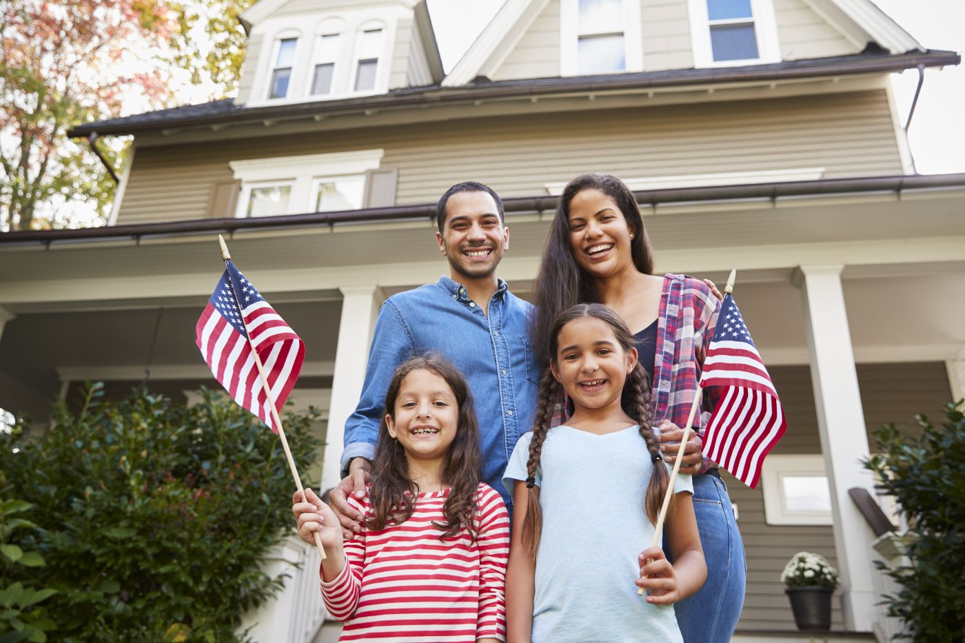 family immigrated to America standing outside home