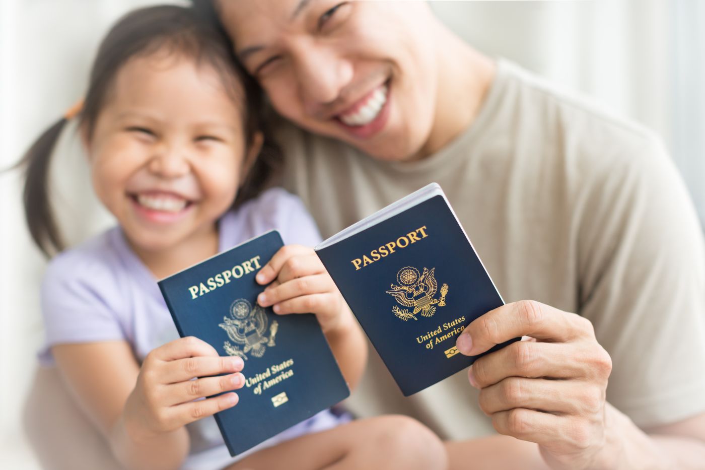 father and daughter holding passports