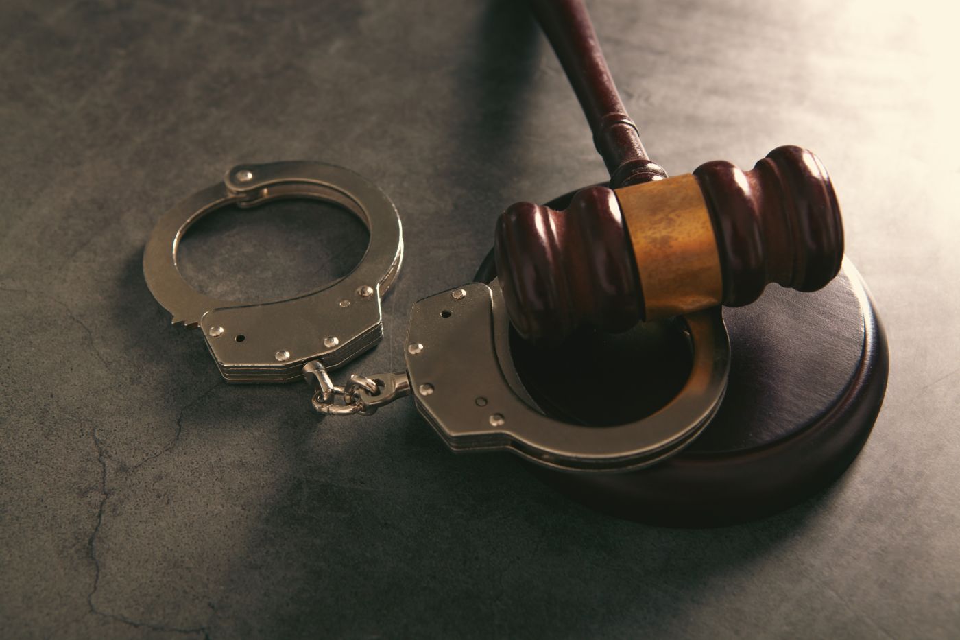 Gavel and handcuff in table