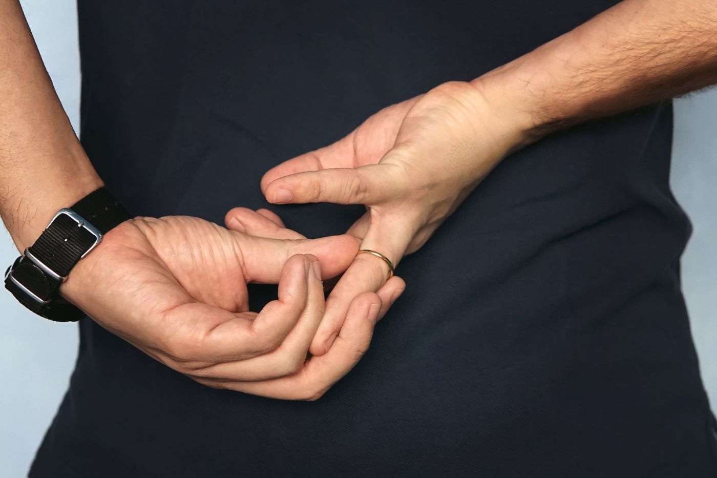 Man taking out wedding ring behind his back