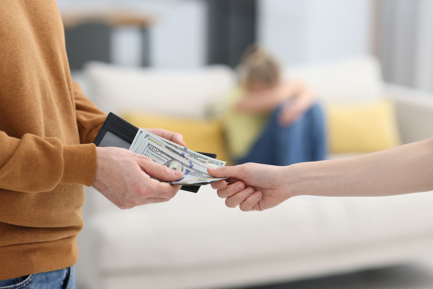 Man handing alimony money to ex-spouse