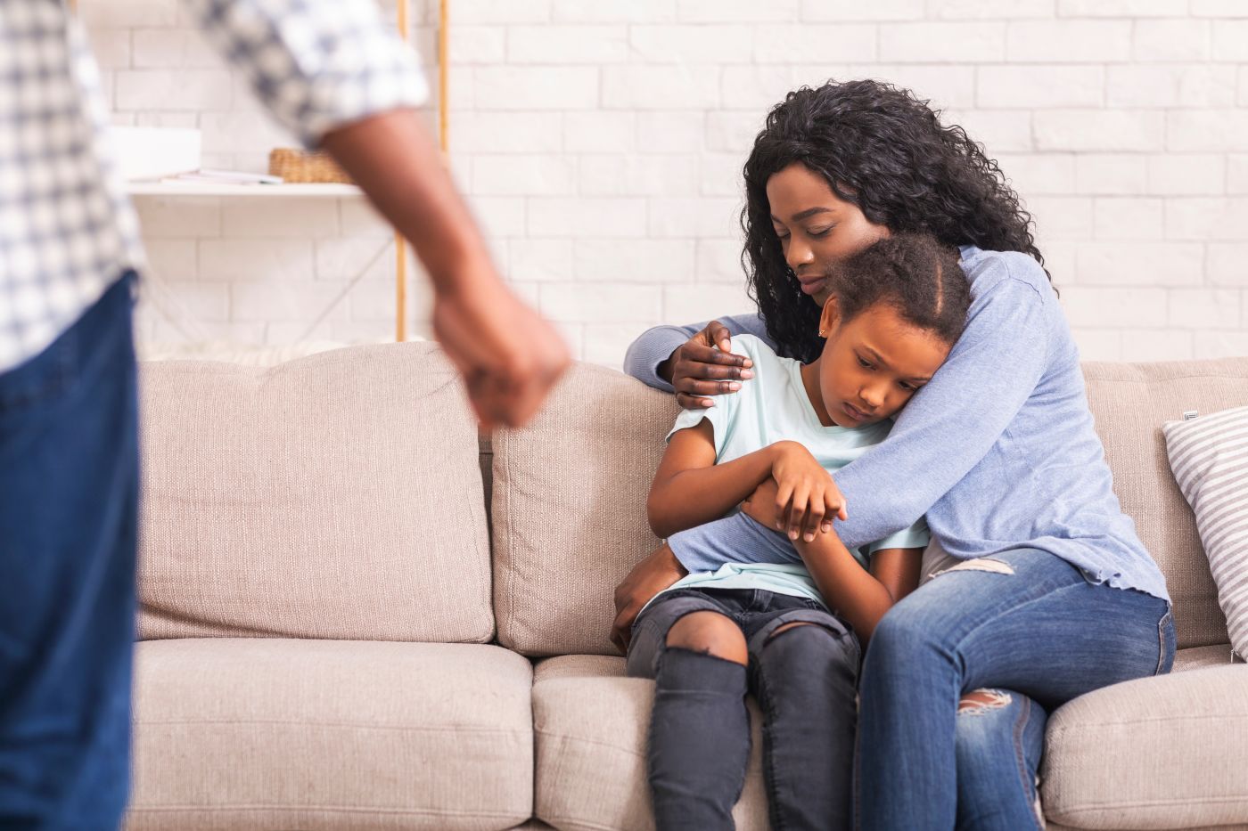 Tight fist of a man with scared mother and daughter