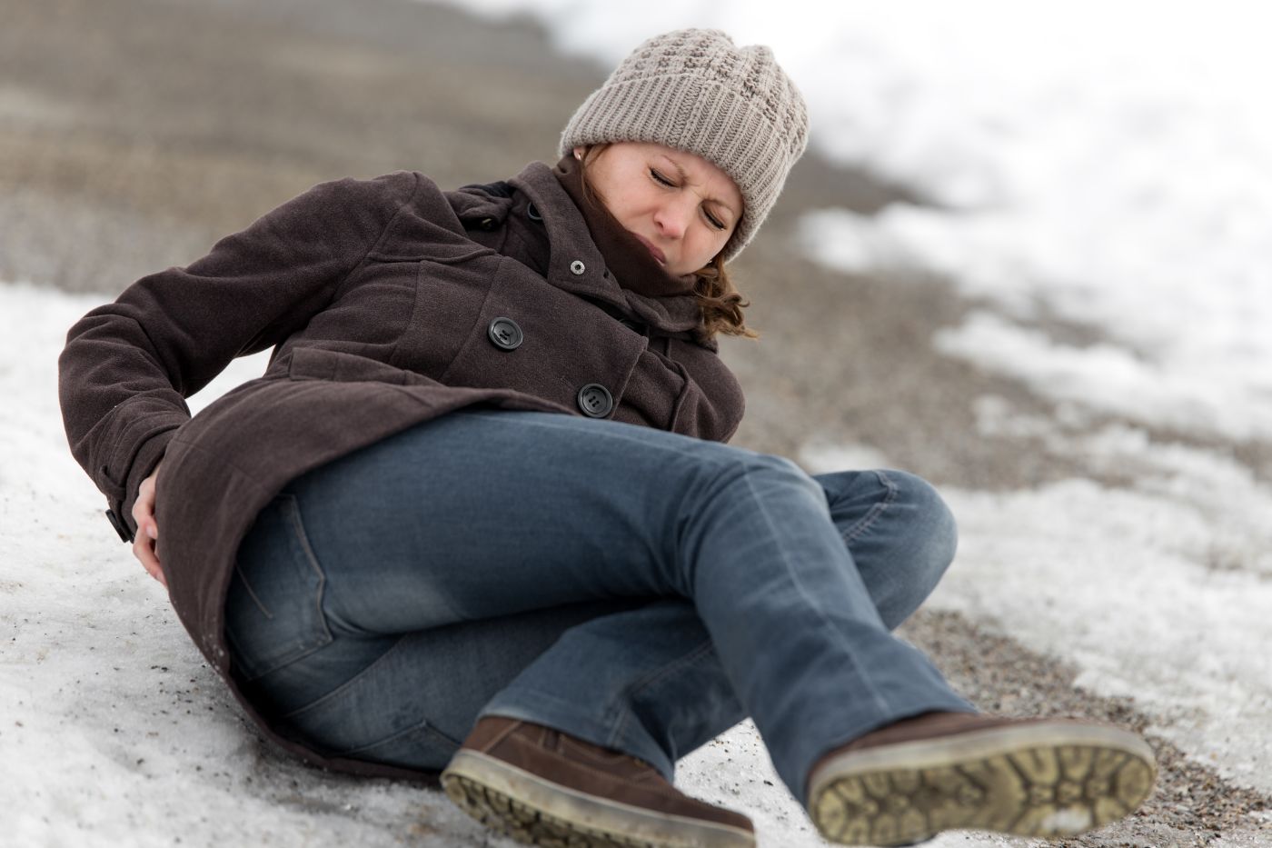 Women slip and fall on icy pavement