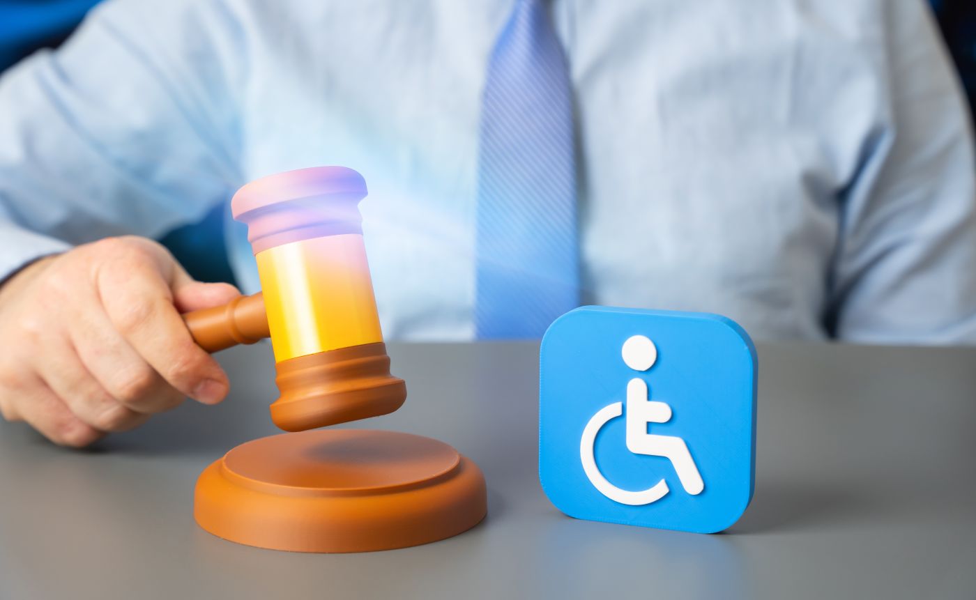 Gavel and disability symbol in table