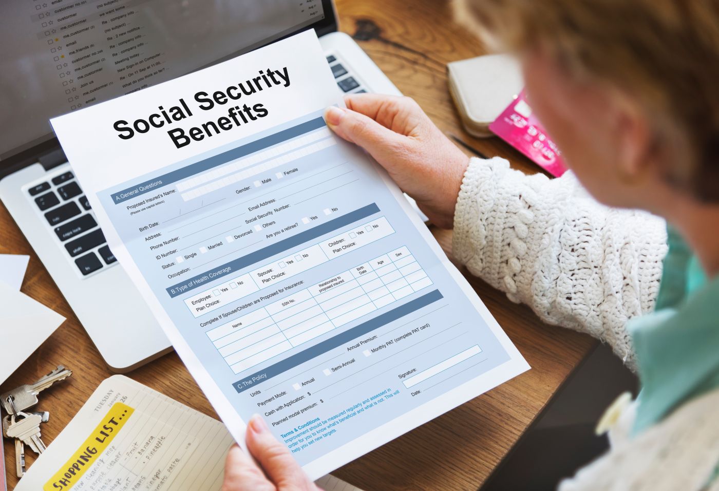 Women holding Social Security Benefit form in hand