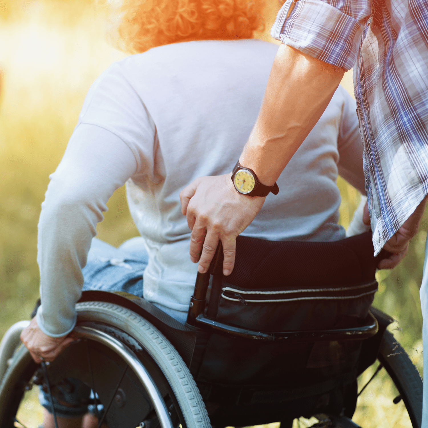 Close up look on woman's back in a wheelchair.