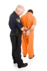 police officed handcuffing man in orange jumpsuit