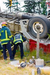 Fireman near overturned semi truck 