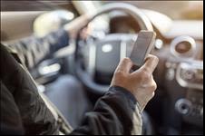 Man looking at phone while driving