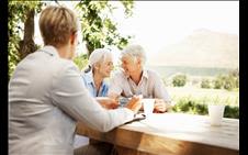 Older couple sitting happily together at a table