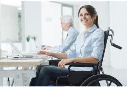 Woman using a wheelchair working