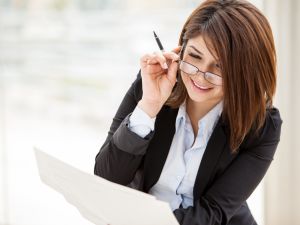 Businesswoman smiling and adjusting glasses