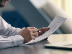 Man in Dress Shirt Reviewing a Document