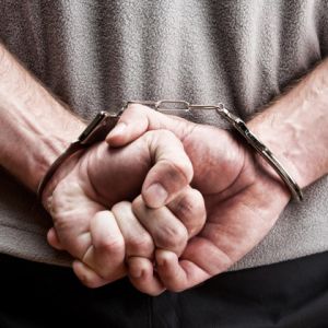 Man handcuffed behind his back