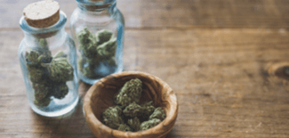 Marijuana in a bowl and glass jars