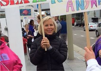 Holly Ennis holding a sign