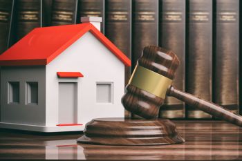 Gavel in front of a home