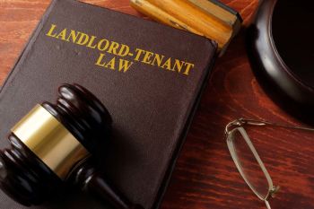 Landlord-Tenant Law book with a gavel on top