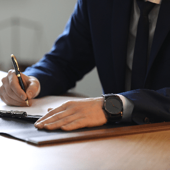 Business man writing at his desk