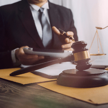 Lawyer working at his desk with a gavel next to him