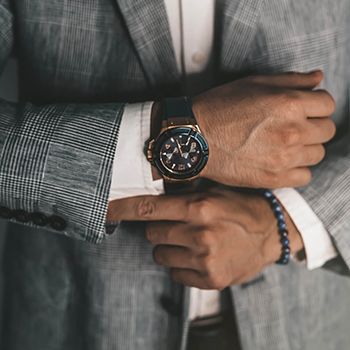 Man in suit adjusting his cuffs
