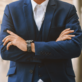 Close up young businessman holding arms folded