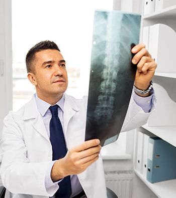 Doctor looking at x-ray of Spinal Cord