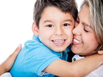 Happy woman holding a smiling boy