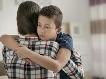 Little boy hugging his mom