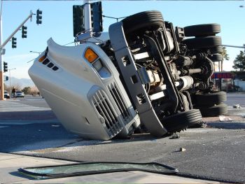 Semi-Truck on it's side in the middle of an intersection