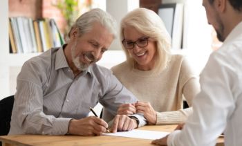 Happy Couple Signing a Document