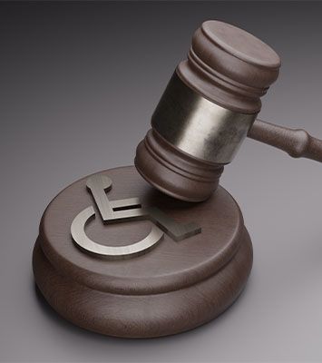 Disabled symbol and judge gavel on gray background