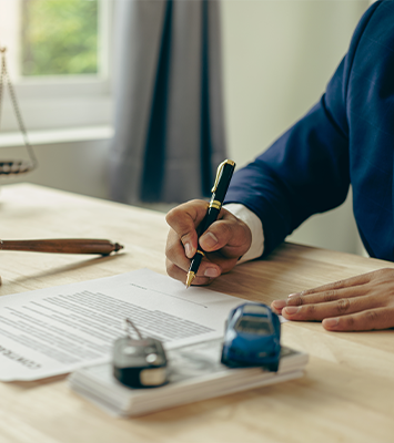 Lawyer, judge's gavel and miniature car on lawyer's table