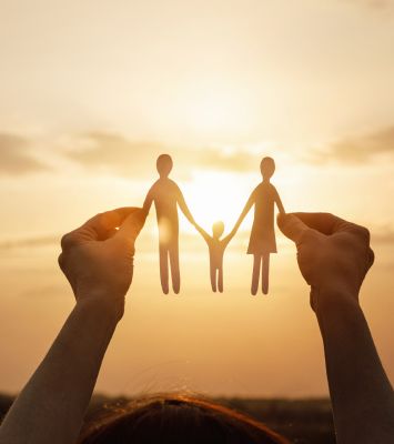 Child holding family figures in hand