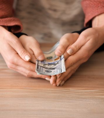 Women and her child holding dollar bill in hand