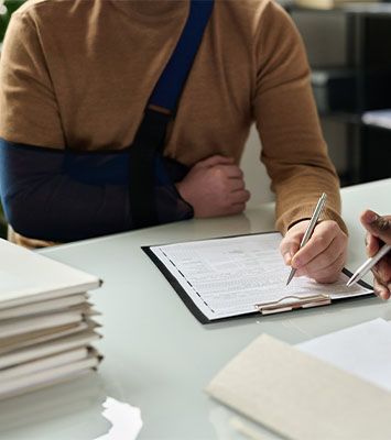 Injured man filling in form