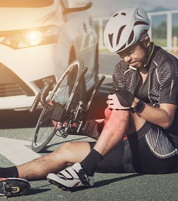 Cyclist injured on the street after accident with car