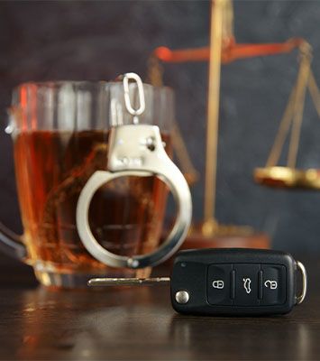 Car Keys, Handcuffs and Glass of Alcohol
