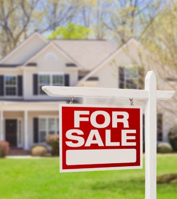 For Sale sign Infront of house