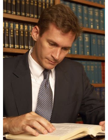 Attorney John M. Kirby Reading Law Book