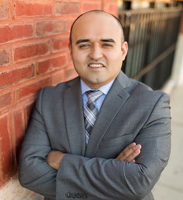 Attorney Anselmo Duran Crossing Arms and Smiling