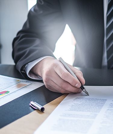 Business man writes on document