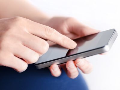 Close up of person's hand scrolling on a phone