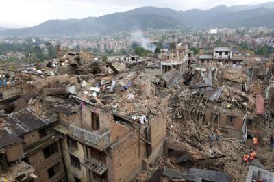 View of Nepal with buildings collapsed and smoke rising