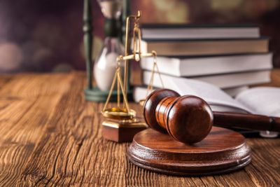 gavel, scales of justice, and stack of books on wood table 