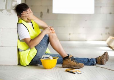 Consruction worker with hand on bloody knee