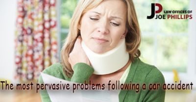 Woman with a neck brace holding her neck