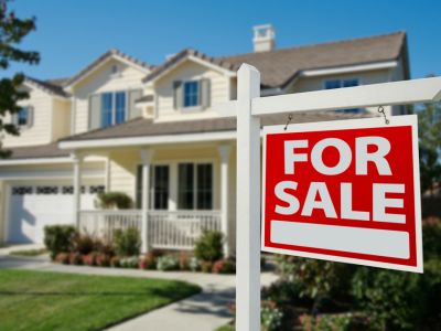 For sale sign in front of house