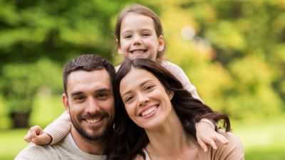 Smiling man, woman, and child 