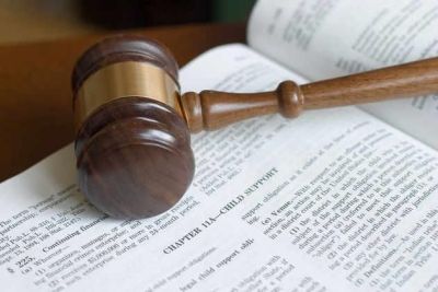 Gavel resting on top of an open book